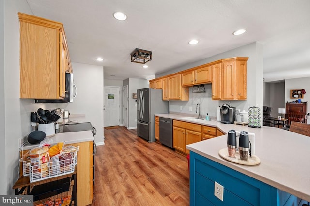 108 Shannon Glen Ct, Louisa, VA 23093 - kitchen featuring appliances with stainless steel finishes, light wood finished floors, light countertops, recessed lighting, and a peninsula