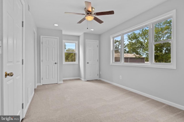 63 Madison St, Warrenton, VA 20186 - unfurnished bedroom with light carpet, multiple windows, recessed lighting, ceiling fan, and multiple closets