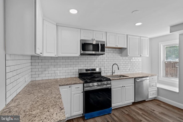 63 Madison St, Warrenton, VA 20186 - kitchen with stainless steel appliances, white cabinetry, dark wood-style floors, light stone counters, and recessed lighting