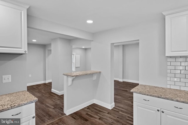 63 Madison St, Warrenton, VA 20186 - kitchen with dark wood finished floors, white cabinetry, light stone countertops, recessed lighting, and backsplash