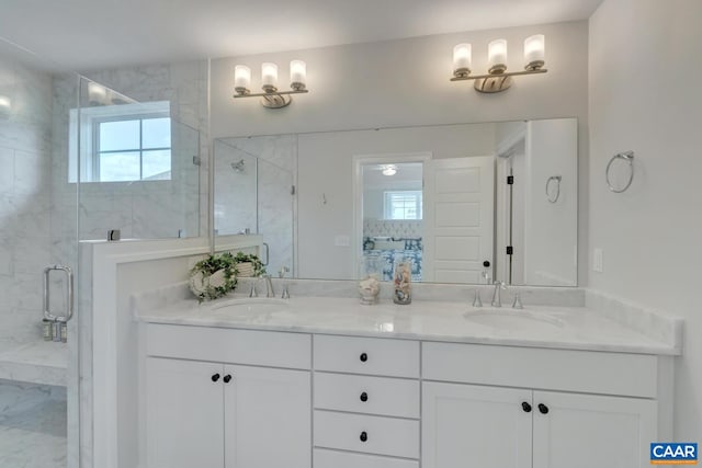 full bath featuring a sink, a marble finish shower, and a healthy amount of sunlight