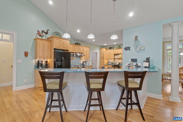 143 Chapel Ct, Palmyra, VA 22963 - kitchen with black fridge, backsplash, light brown cabinets, a kitchen breakfast bar, and recessed lighting