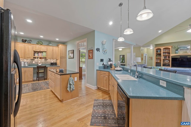143 Chapel Ct, Palmyra, VA 22963 - kitchen featuring a sink, black appliances, dark countertops, light wood finished floors, and a peninsula