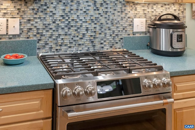 143 Chapel Ct, Palmyra, VA 22963 - kitchen view of stainless steel gas range oven, decorative backsplash, and light brown cabinets