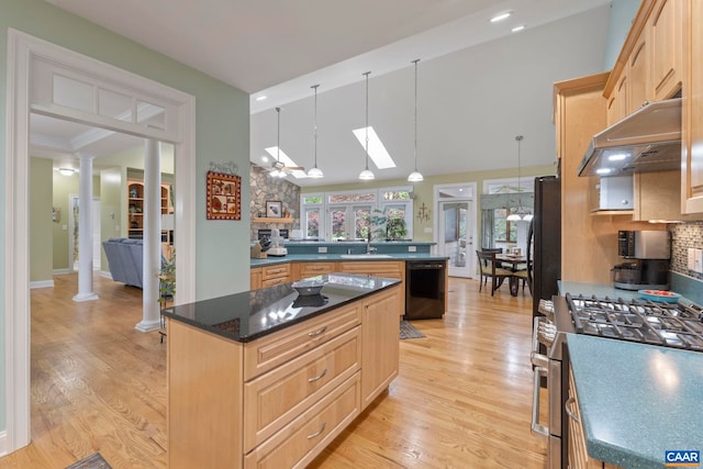 143 Chapel Ct, Palmyra, VA 22963 - kitchen with gas range, under cabinet range hood, a skylight, decorative columns, and light brown cabinets