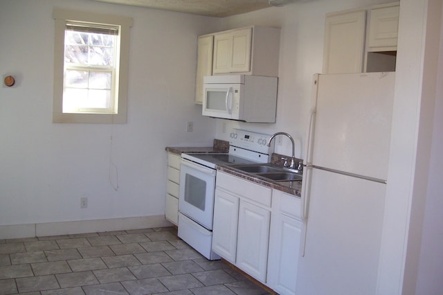 17156 Red Brush Rd, Elkton, VA 22827 - kitchen with white cabinets, dark countertops, a sink, and white appliances