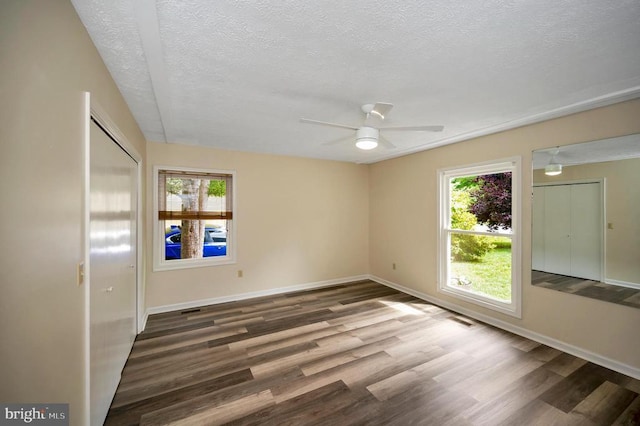 141 Eagle Ct, Locust Grove, VA 22508 - unfurnished bedroom with multiple windows, a textured ceiling, wood finished floors, baseboards, and ceiling fan