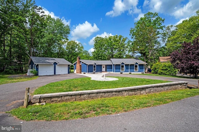 141 Eagle Ct, Locust Grove, VA 22508 - single story home with driveway, a front yard, a chimney, and an outbuilding