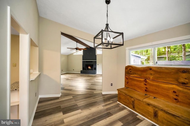 141 Eagle Ct, Locust Grove, VA 22508 - dining space with a brick fireplace, dark wood finished floors, a chandelier, ceiling fan, and baseboards