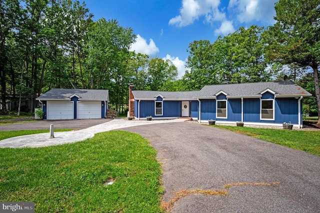 141 Eagle Ct, Locust Grove, VA 22508 - single story home with a front yard, a detached garage, a chimney, and an outbuilding