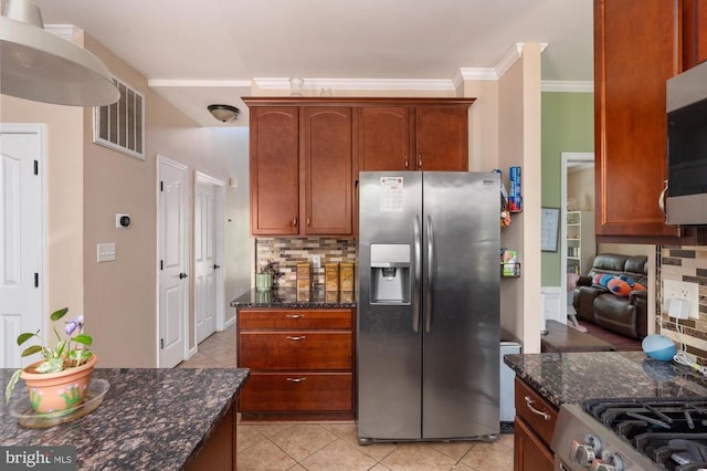 5930 Copper Mountain Dr W, Spotsylvania, VA 22553 - kitchen featuring appliances with stainless steel finishes, tasteful backsplash, light tile patterned flooring, dark stone counters, and crown molding