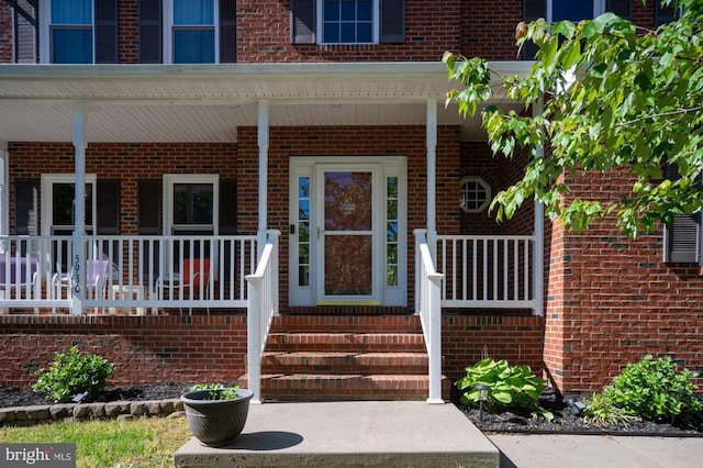 5930 Copper Mountain Dr W, Spotsylvania, VA 22553 - view of exterior entry with covered porch and brick siding