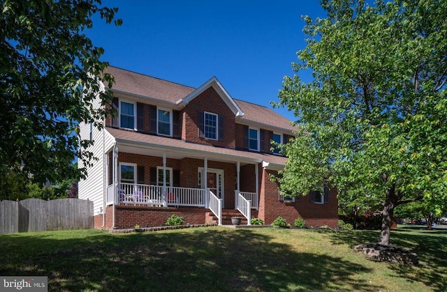 5930 Copper Mountain Dr W, Spotsylvania, VA 22553 - view of front of property with a porch, a front lawn, roof with shingles, and brick siding