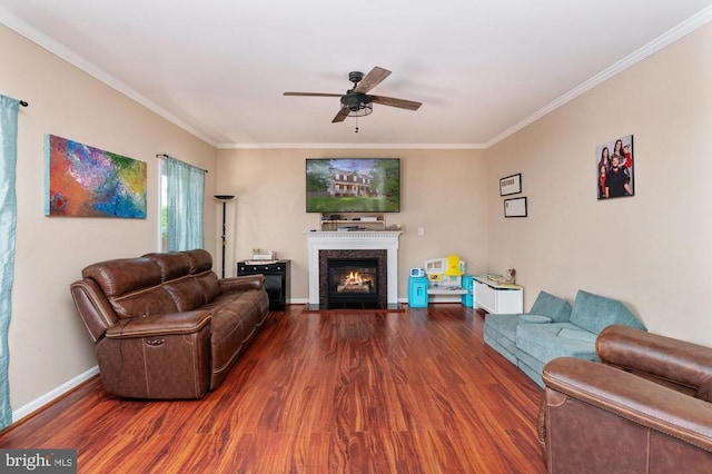 5930 Copper Mountain Dr W, Spotsylvania, VA 22553 - living area with wood finished floors, crown molding, a ceiling fan, a fireplace with flush hearth, and baseboards
