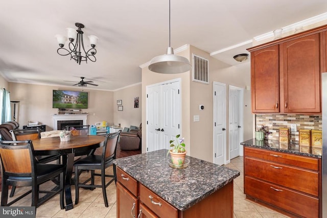 5930 Copper Mountain Dr W, Spotsylvania, VA 22553 - kitchen featuring ceiling fan, a fireplace, light tile patterned floors, open floor plan, and crown molding