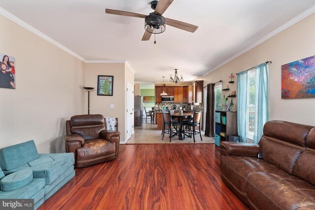 5930 Copper Mountain Dr W, Spotsylvania, VA 22553 - living room with wood finished floors, crown molding, a ceiling fan, a chandelier, and baseboards