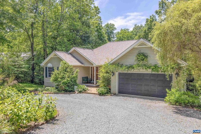 56 Wildwood Dr, Palmyra, VA 22963 - view of front of house with driveway, a garage, a shingled roof, and covered porch