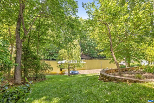 56 Wildwood Dr, Palmyra, VA 22963 - view of green lawn with a water view, a boat dock, and a wooded view