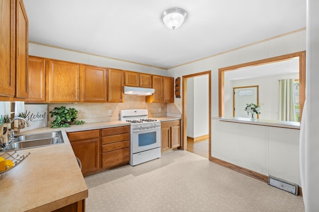 816 Rutherford St, Staunton, VA 24401 - kitchen with white range with gas stovetop, under cabinet range hood, light countertops, and light flooring
