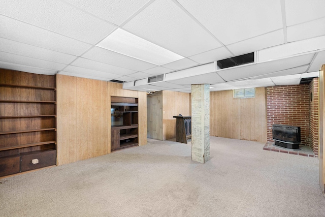 816 Rutherford St, Staunton, VA 24401 - basement featuring a wood stove, carpet flooring, wooden walls, and a drop ceiling