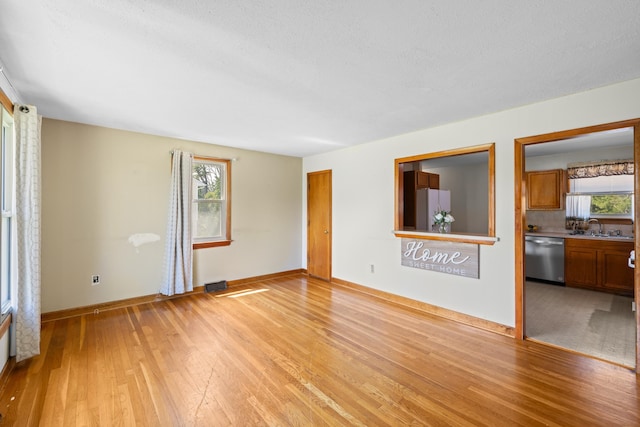 816 Rutherford St, Staunton, VA 24401 - unfurnished living room with light wood-style flooring and a sink