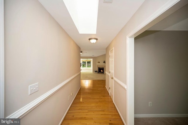 317 Edgehill Dr, Locust Grove, VA 22508 - hallway with a skylight, light wood-type flooring, and baseboards