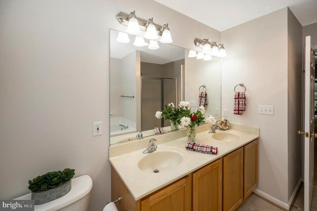 317 Edgehill Dr, Locust Grove, VA 22508 - bathroom featuring a stall shower, double vanity, and toilet