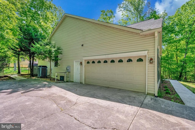 317 Edgehill Dr, Locust Grove, VA 22508 - view of home's exterior with driveway, a shingled roof, central AC, and an attached garage