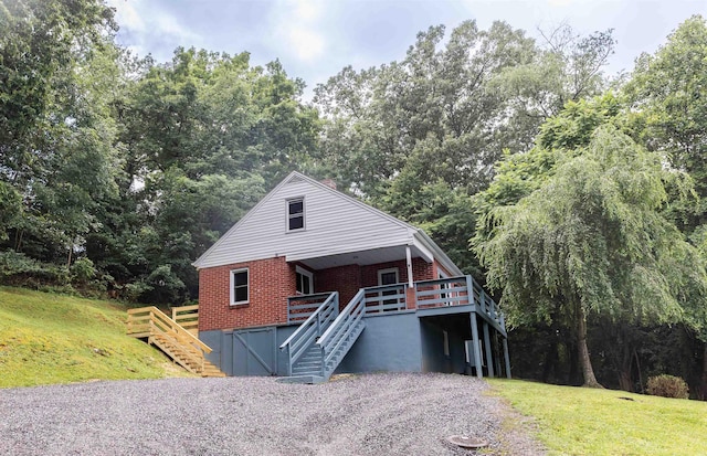 164 28th St E, Buena Vista, VA 24416 - view of front facade featuring brick siding, stairs, a deck, and a front yard