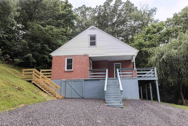 164 28th St E, Buena Vista, VA 24416 - view of front of house with stairway, brick siding, and a deck