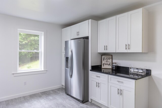 164 28th St E, Buena Vista, VA 24416 - kitchen with stainless steel fridge, white cabinets, and light wood finished floors
