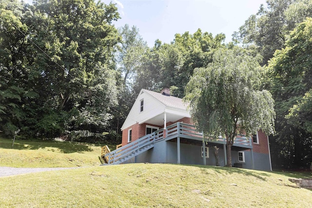 164 28th St E, Buena Vista, VA 24416 - view of side of home featuring a lawn, stairs, a wooden deck, and brick siding