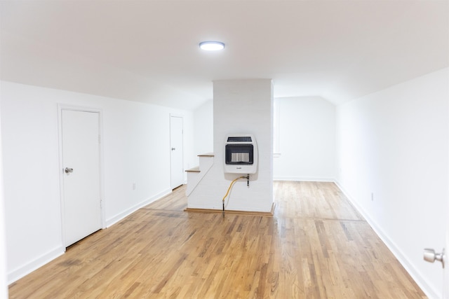 164 28th St E, Buena Vista, VA 24416 - unfurnished living room with heating unit, vaulted ceiling, and light wood-type flooring