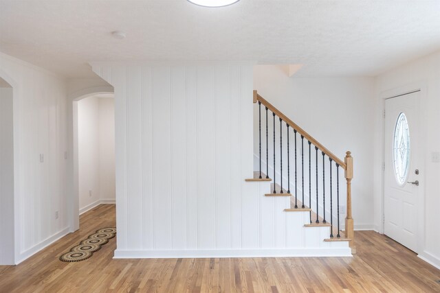 164 28th St E, Buena Vista, VA 24416 - foyer with arched walkways, wood finished floors, and stairs