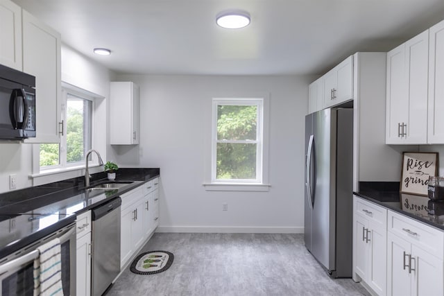 164 28th St E, Buena Vista, VA 24416 - kitchen featuring stainless steel appliances, healthy amount of natural light, and white cabinetry