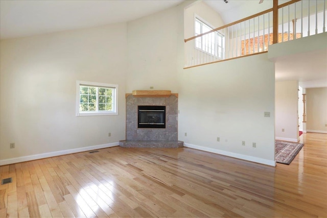114 Meagans Run Rd, Woodstock, VA 22664 - unfurnished living room with high vaulted ceiling, wood-type flooring, and a tile fireplace