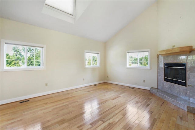 114 Meagans Run Rd, Woodstock, VA 22664 - unfurnished living room featuring light wood-style floors, healthy amount of natural light, a high end fireplace, and high vaulted ceiling