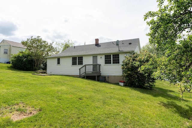 back of house with a yard and a chimney
