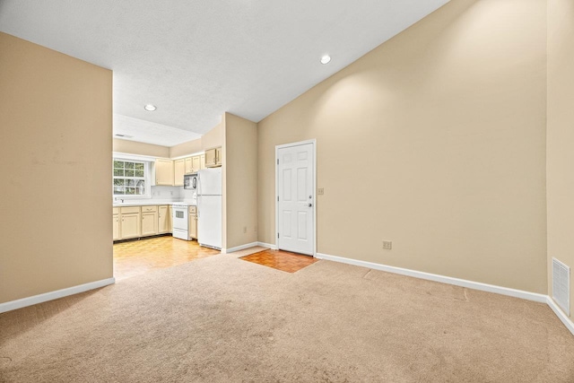 127 Emerald Dr, Harrisonburg, VA 22801 - unfurnished living room featuring light carpet, baseboards, lofted ceiling, and recessed lighting