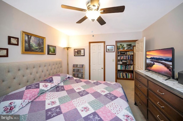 bedroom with light carpet and a ceiling fan