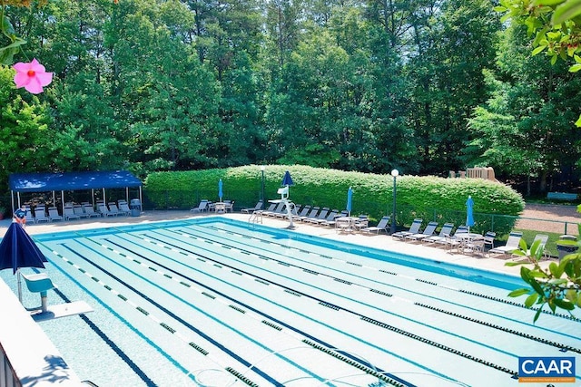 community pool featuring fence and a patio