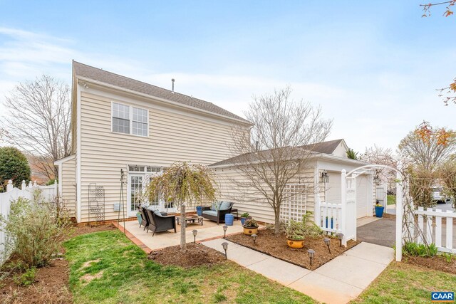 back of property with fence and an outdoor living space