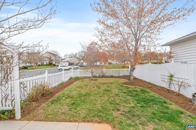 view of yard featuring a fenced backyard and a residential view
