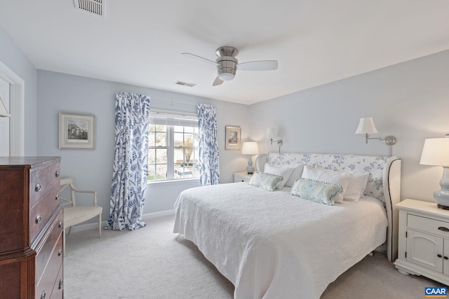 bedroom featuring light colored carpet, a ceiling fan, and visible vents