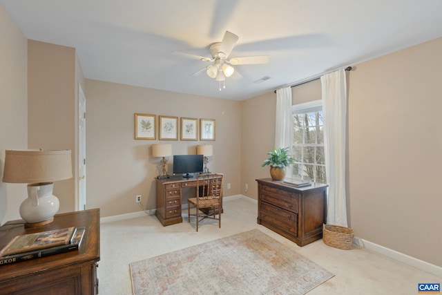 home office featuring carpet flooring, baseboards, a ceiling fan, and visible vents