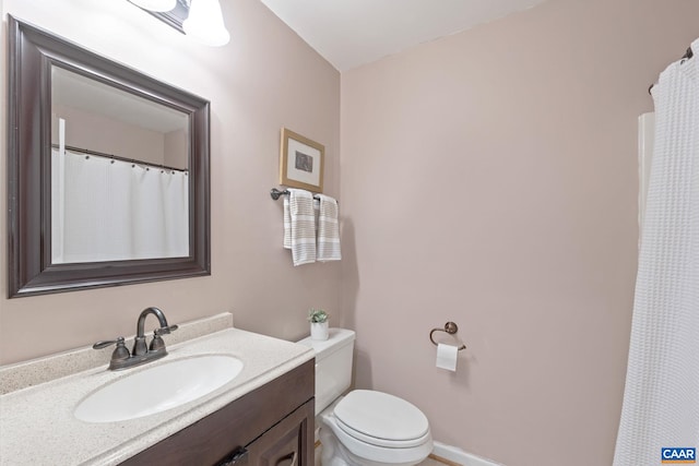 bathroom with toilet and vanity