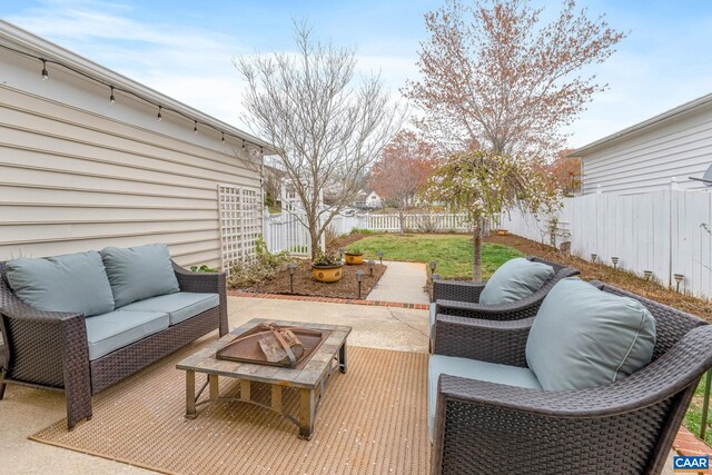 view of patio / terrace featuring a deck, an outdoor living space with a fire pit, and a fenced backyard