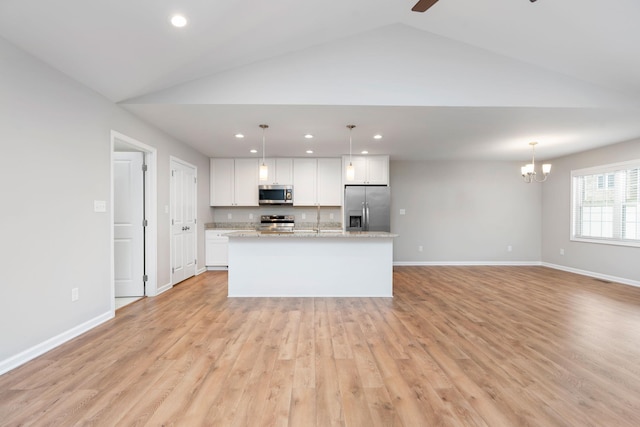 121 Lake View Cir, Waynesboro, VA 22980 - kitchen with lofted ceiling, baseboards, white cabinets, and appliances with stainless steel finishes