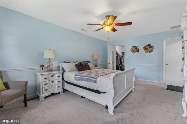  - bedroom featuring light colored carpet, a spacious closet, a closet, and baseboards