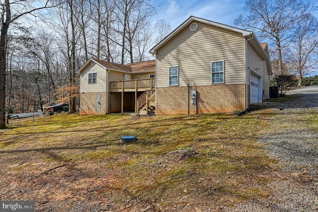 135 Bluewater Blvd S, Mineral, VA 23117 - back of house featuring central AC unit, a wooden deck, brick siding, a garage, and stairs